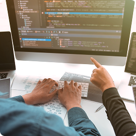 From demo to deployment blog header with two people pointing at the screen