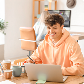 Person at work, happily working on a laptop