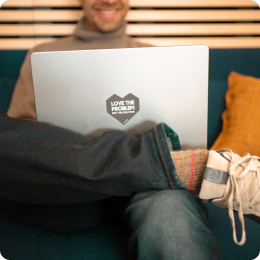 Man on a sofa working on his laptop