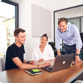 People at work discussing over a shared laptop